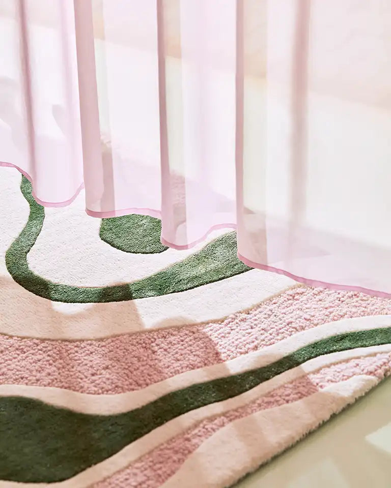 Textured pink and green rug with a patterned surface